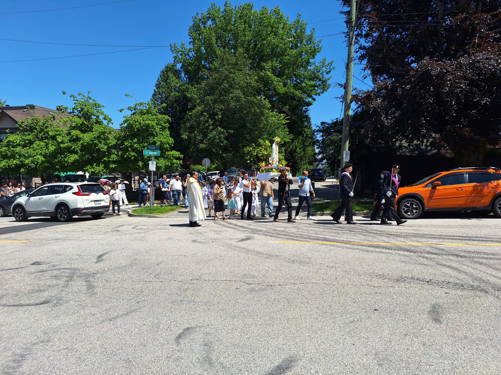 Wide view of the Marian Procession crossing the street near St. Joseph Parish