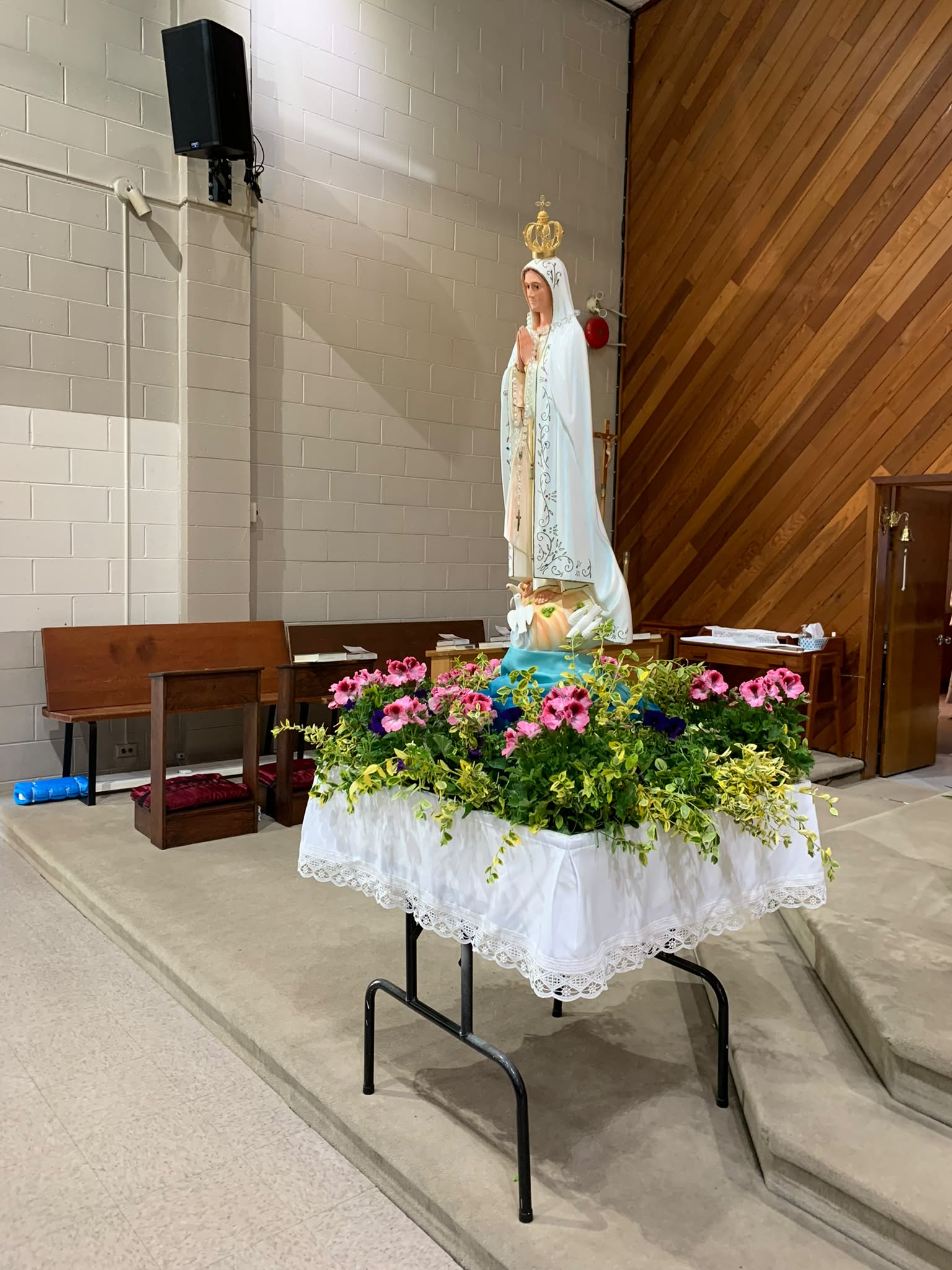 Mary's statue on the completed float with flowers
