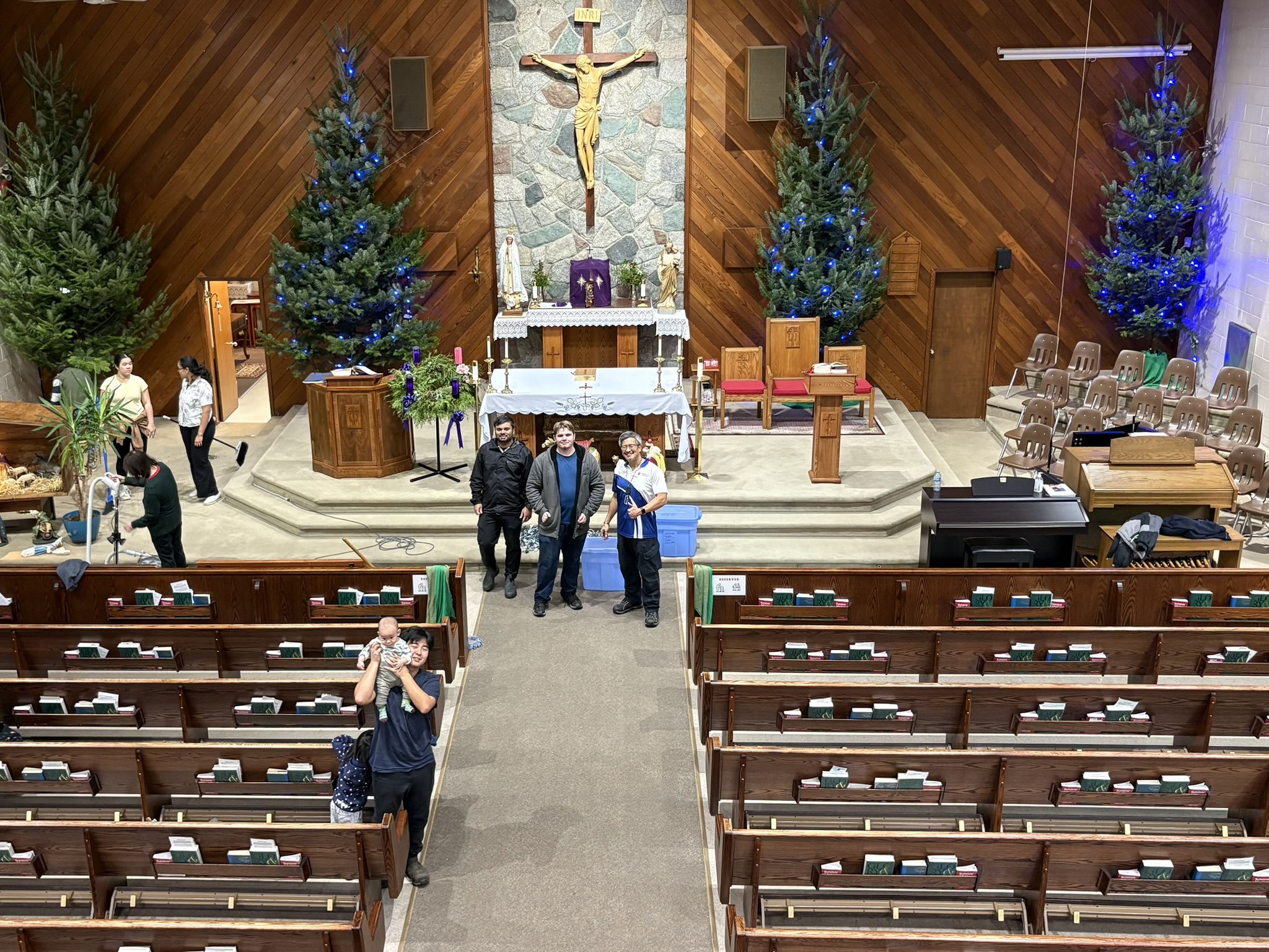 Carrying trunks toward the church entrance together.