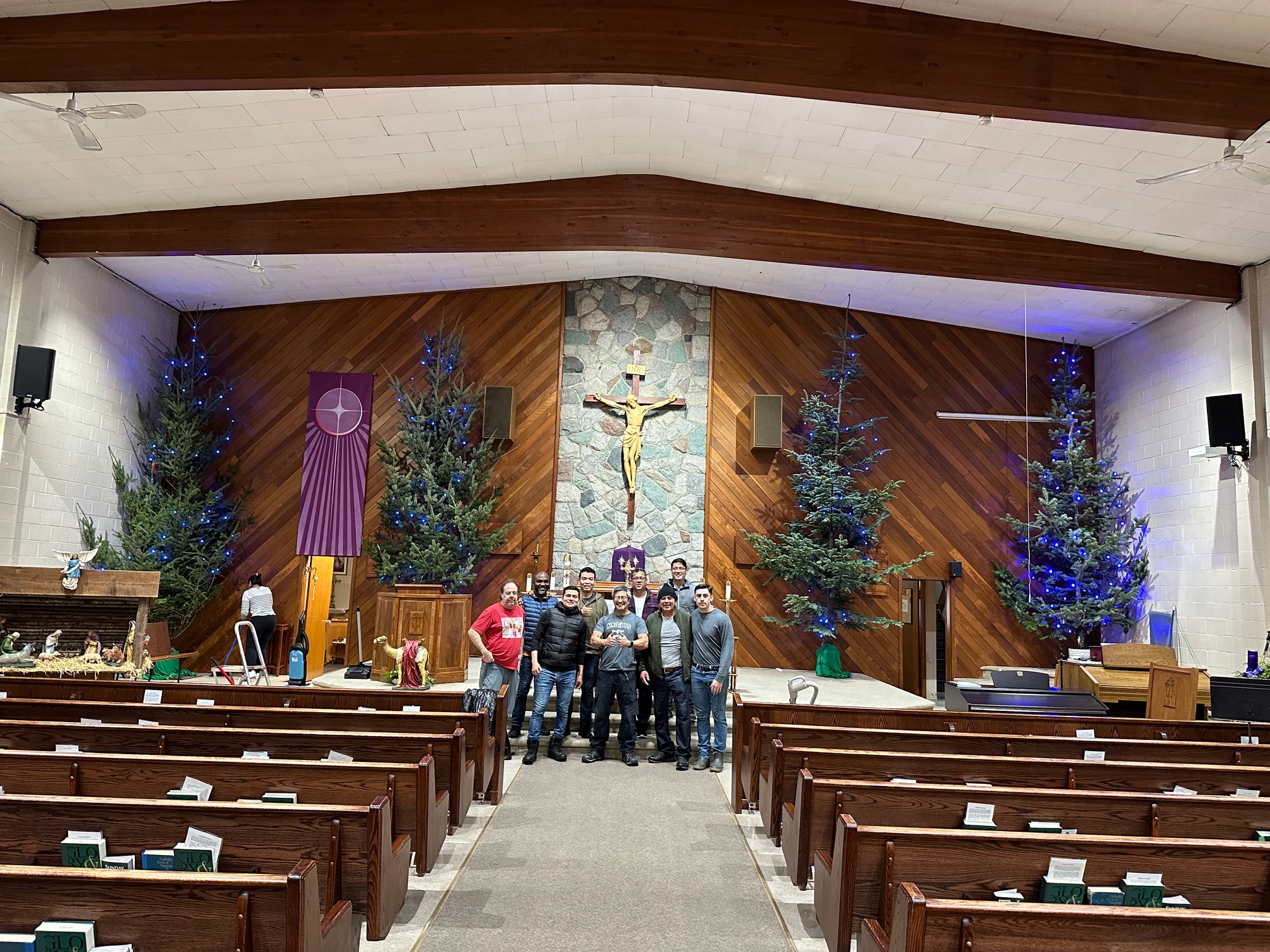 Christmas trees raised in the sanctuary at St. Joseph